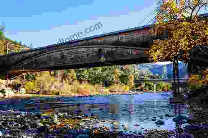 An Aerial View Of A Covered Bridge Spanning A Wide River, Surrounded By Lush Greenery New York Covered Bridges Harold Stiver